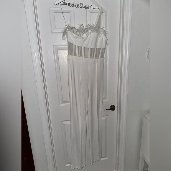 White jumpsuit. Fashion Nova size M. Worn twice. Feathers on the top. - Picture 1 of 3